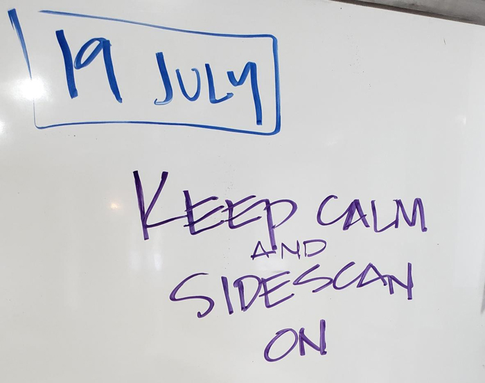 Whiteboard reads "Keep Calm and Sidescan On" Samoan Clipper Search Update 7-19-19 update 2